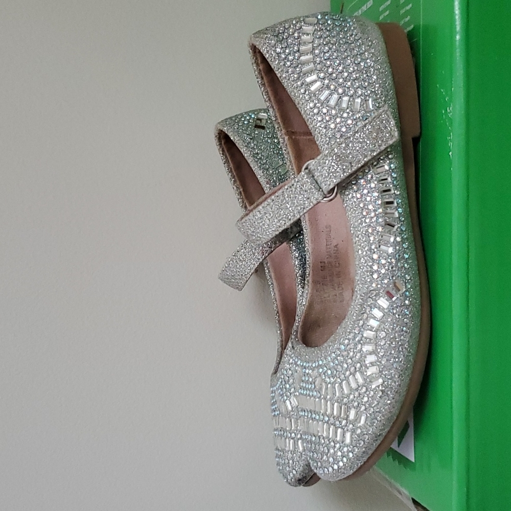 A silver metallic dress shoe by olive & edie